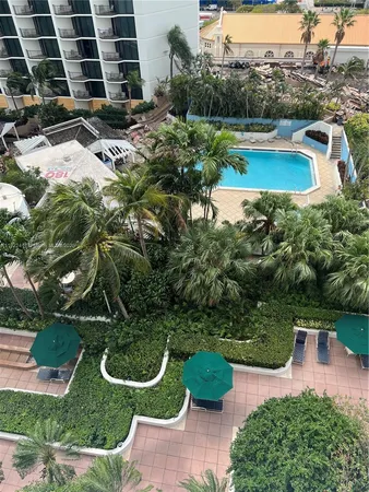 an aerial view of a house with garden space and lake view