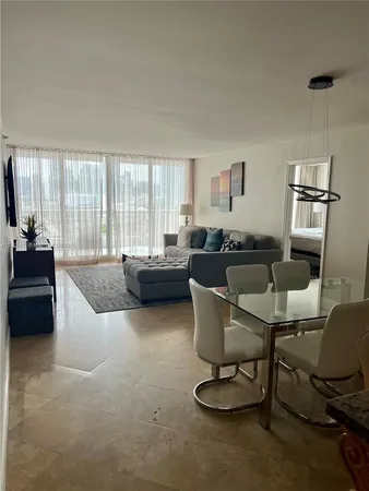 a living room with furniture a large window and a flat screen tv