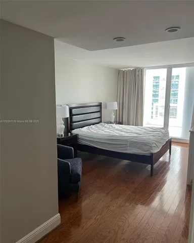 a bedroom with furniture and wooden floor