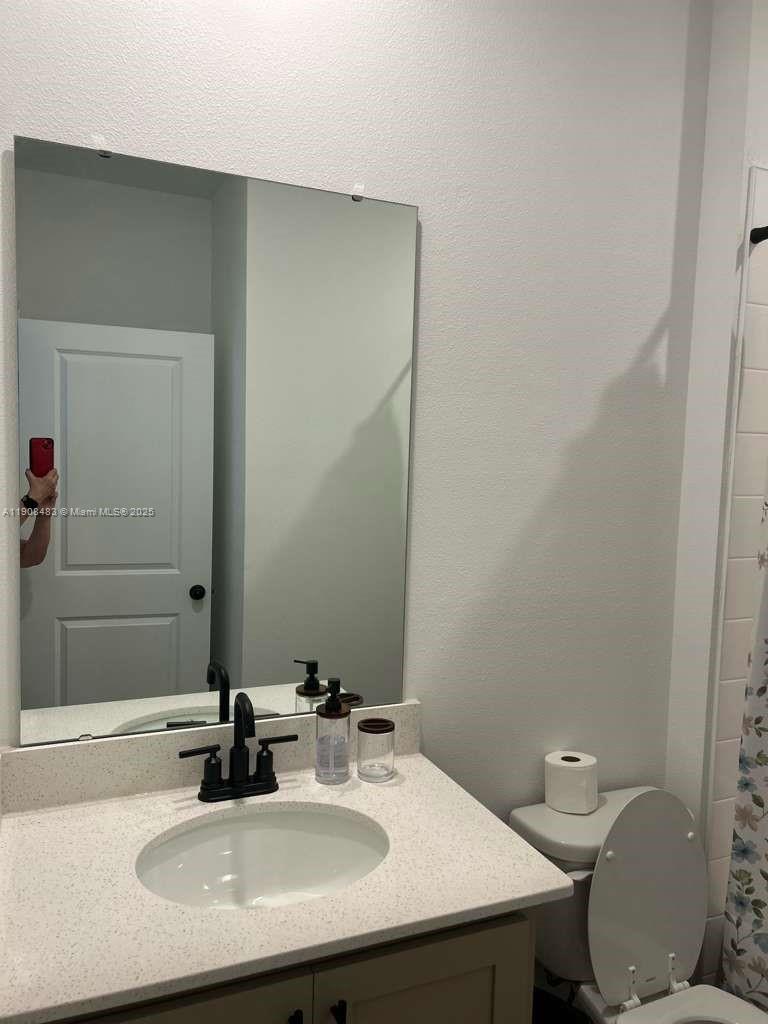 2952 Embark Trail, Unit D134 St. Cloud, FL 34771 - Photo 11 of 12 a bathroom with a sink and a toilet