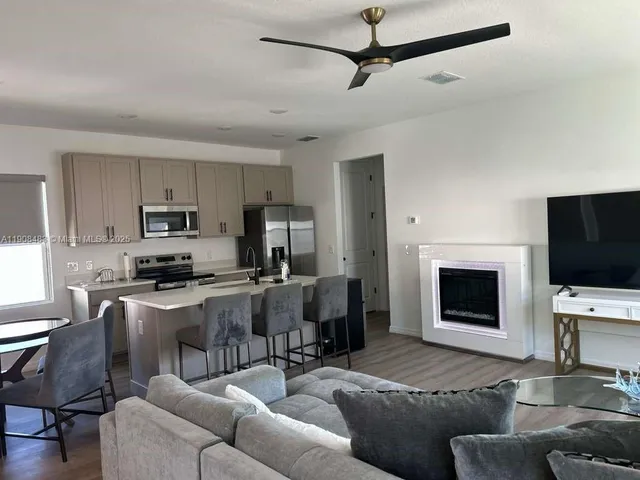 a living room with furniture a fireplace and a flat screen tv