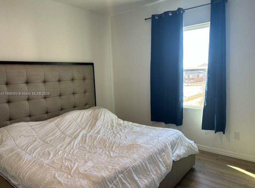 2952 Embark Trail, Unit D134 St. Cloud, FL 34771 - Photo 9 of 12 a bedroom with a bed and a window