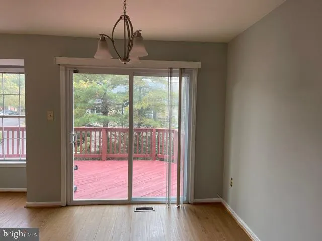 a view of a room with wooden floor and windows