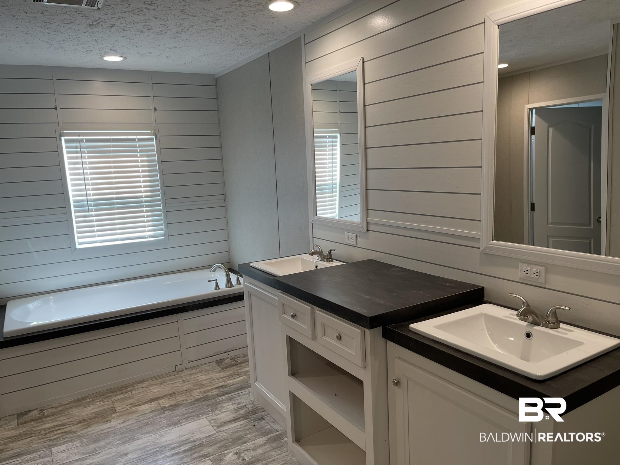 16802 County Road 87 Elberta, AL 36530 - Photo 8 of 19 Bathroom with a textured ceiling, a garden tub, light wood-style flooring, two vanities, and recessed lighting