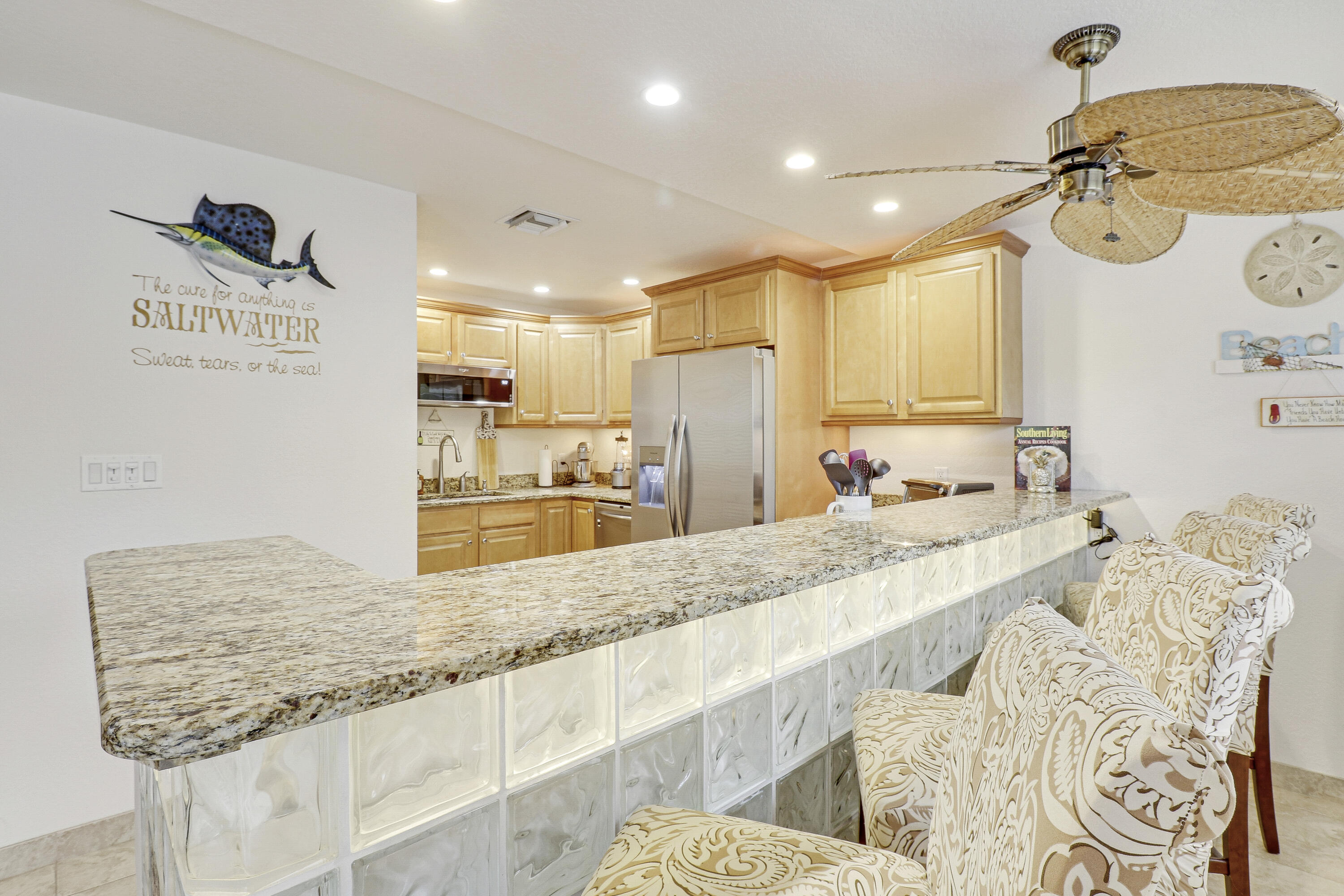 a large kitchen with kitchen island a sink stainless steel appliances and living room view