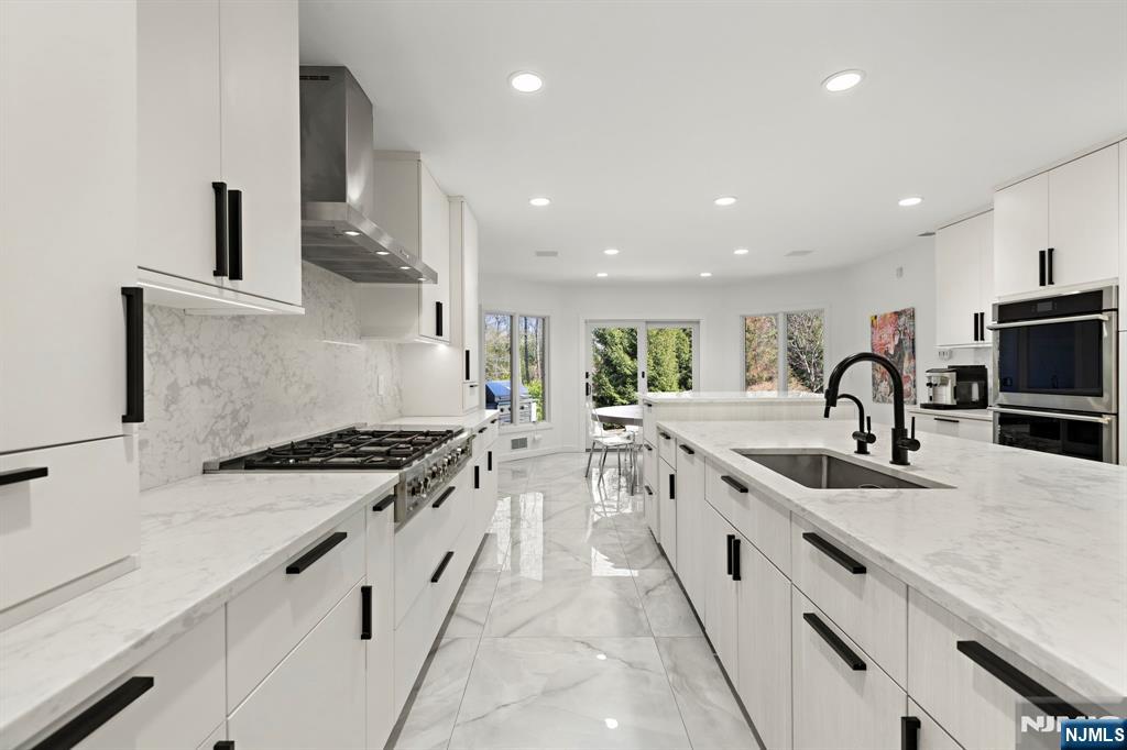 425 Highview Road Englewood, NJ 07631 - Photo 14 of 48 a large kitchen with stainless steel appliances granite countertop a lot of white cabinets and sink