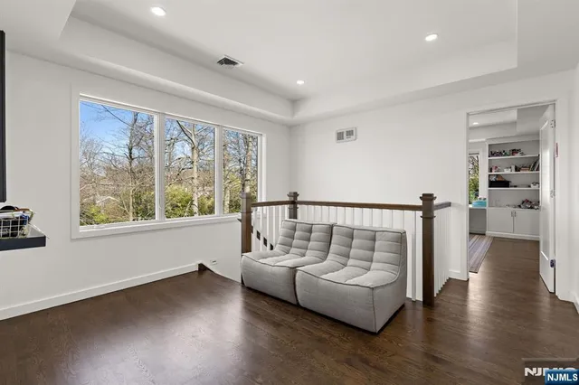 a bedroom with a large bed and windows