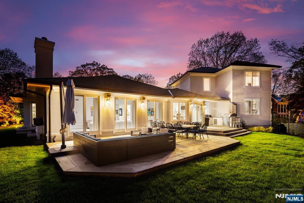 425 Highview Road Englewood, NJ 07631 - Photo 2 of 48 a front view of a house with a yard table and chairs