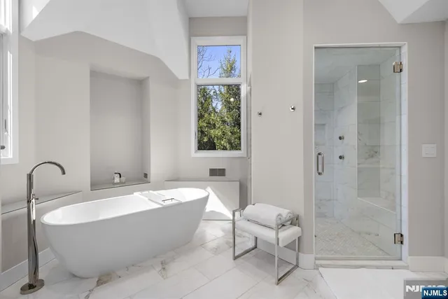 a spacious bathroom with a bathtub and a sink