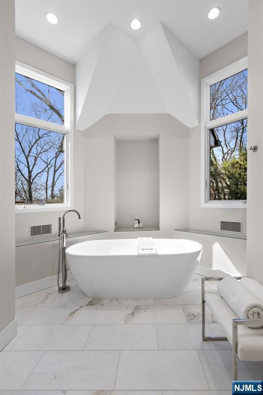 425 Highview Road Englewood, NJ 07631 - Photo 24 of 48 a spacious bathroom with a bathtub and a sink