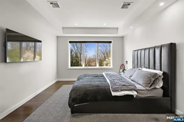 a bedroom with a bed and a large window
