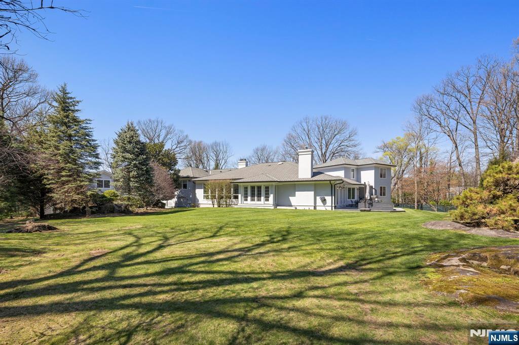 425 Highview Road Englewood, NJ 07631 - Photo 38 of 48 a front view of a house with a garden