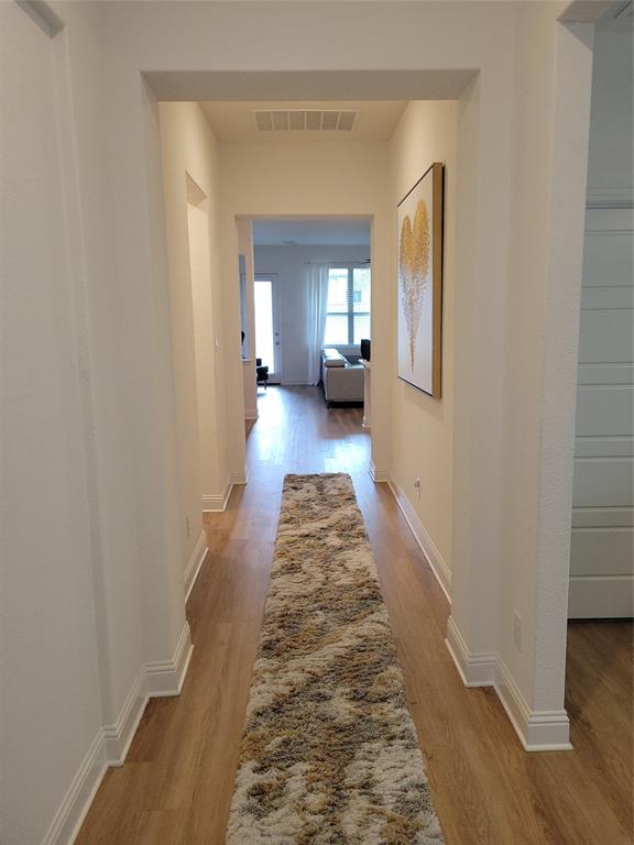 7024 Tree Stand Point Little Elm, TX 76227 - Photo 4 of 30 a hallway with a window and a rug