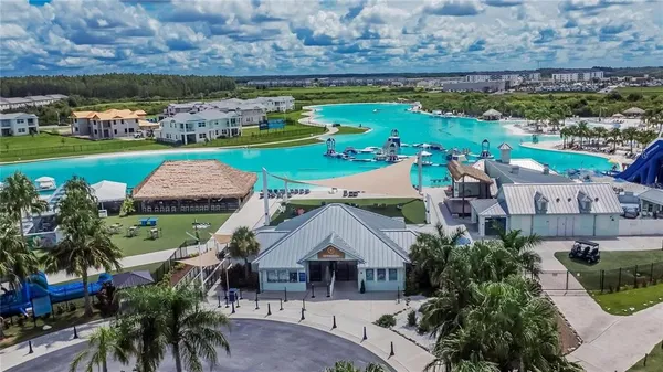 an aerial view of a house with a garden and swimming pool