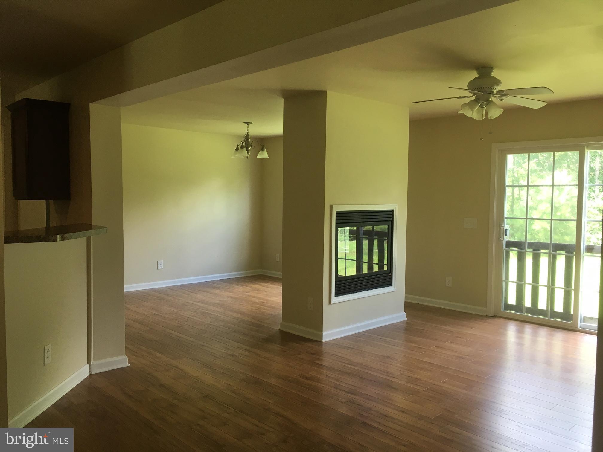 7526 Leedstown Road Colonial Beach, VA 22443 - Photo 3 of 30 Living Room/Dining Room Separated by Fireplace