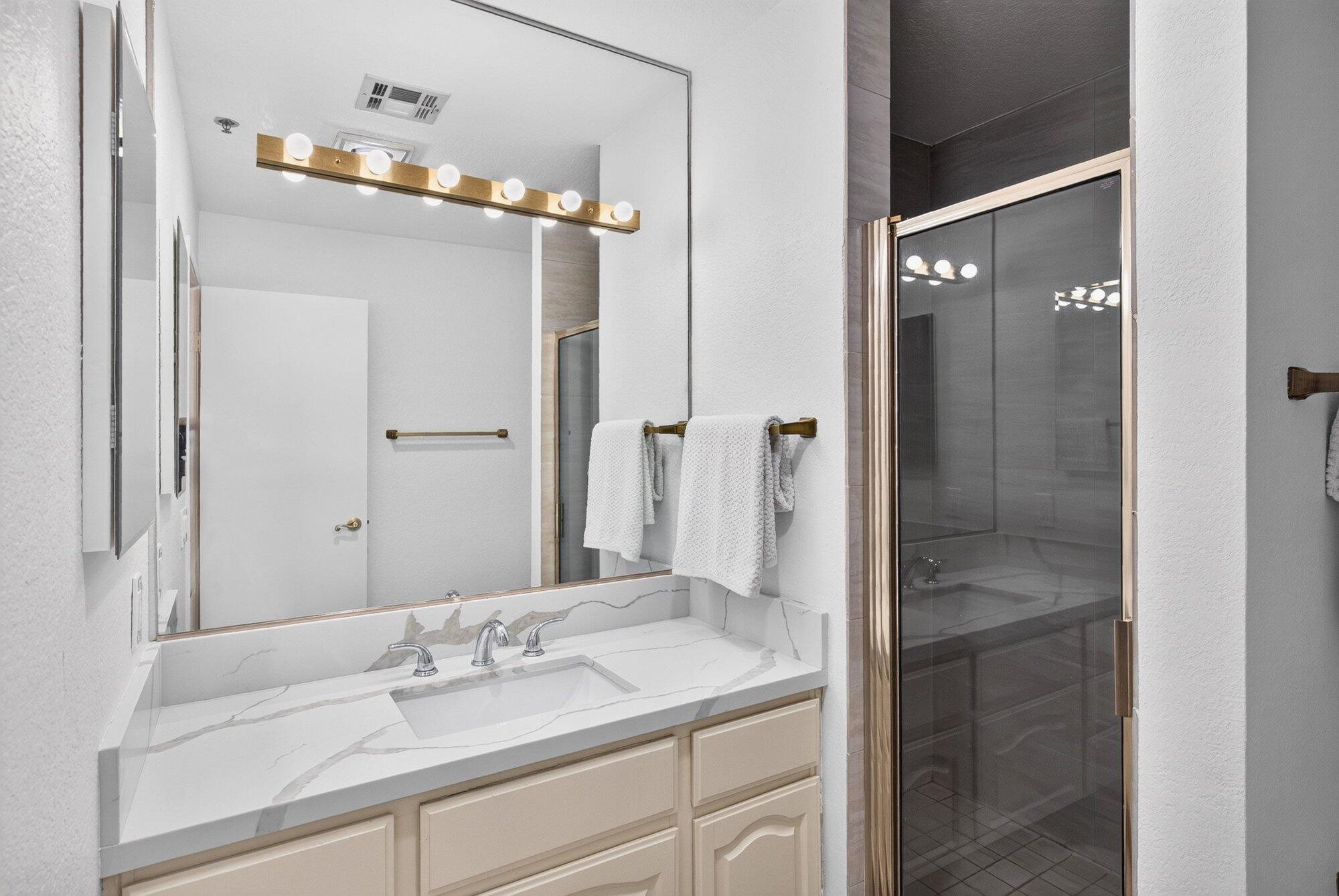 500 East Amado Road, Unit 313 Palm Springs, CA 92262 - Photo 14 of 32 a bathroom with a sink and a mirror