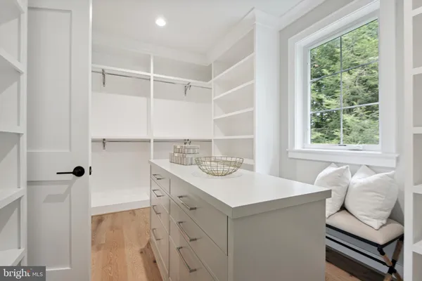 a spacious bedroom with a large bed and a large window