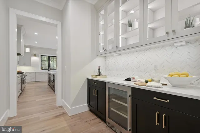 a large kitchen with kitchen island a island a sink a stove a dining table and chairs