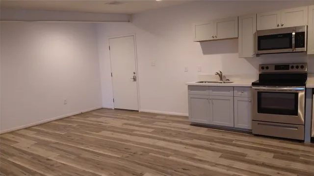 a view of a kitchen with electric appliances