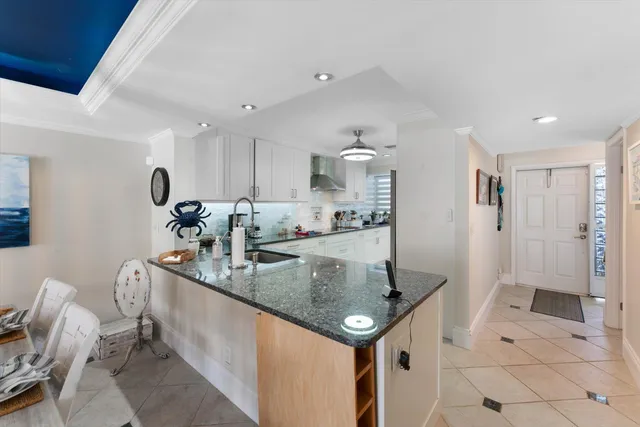 a kitchen with stainless steel appliances granite countertop a sink and refrigerator