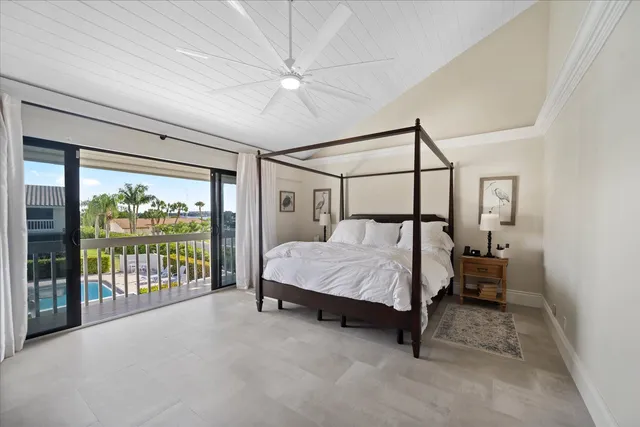 a bedroom with a bed and large window