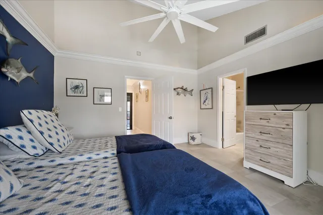 a bedroom with a bed and a television