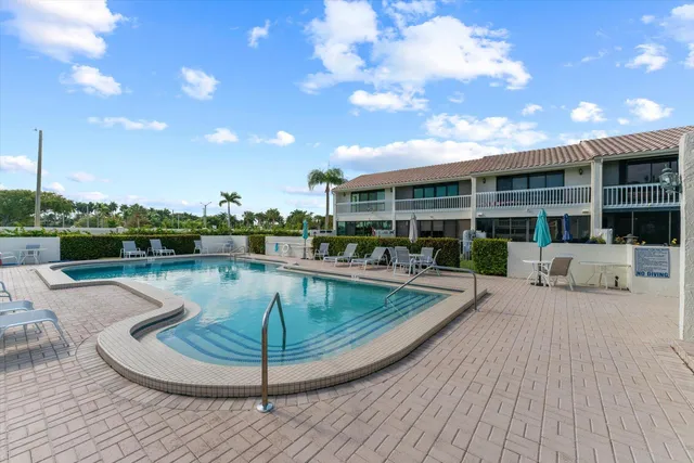 a view of a swimming pool with a patio and a garden