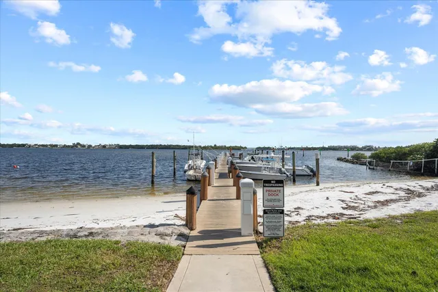 a view of a ocean with a big yard and large trees