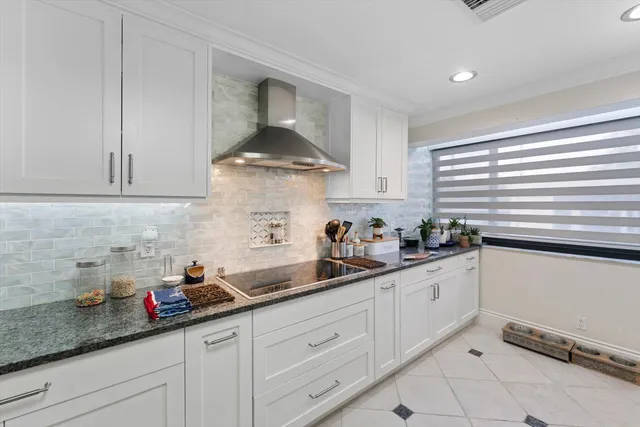 a kitchen with stainless steel appliances a sink a stove and cabinets