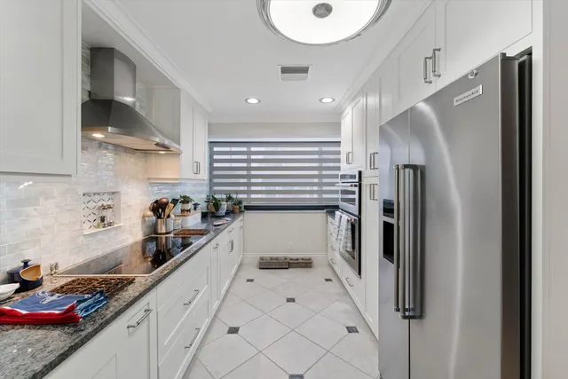 a kitchen with stainless steel appliances a refrigerator and a sink