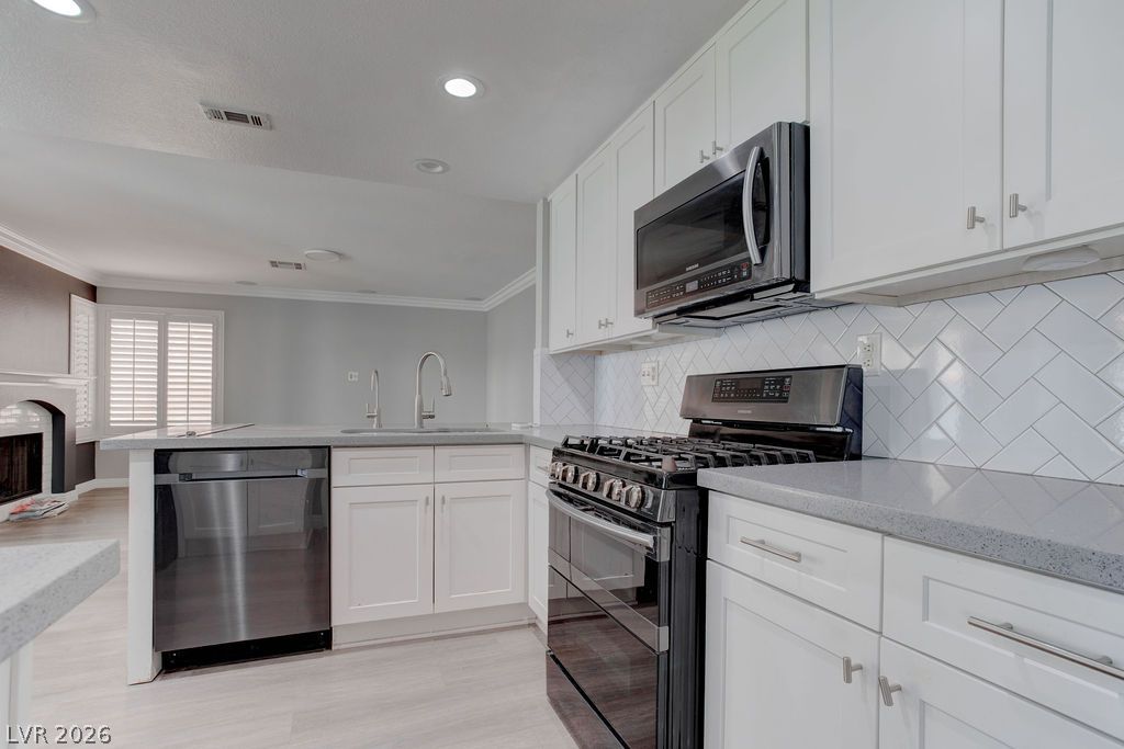 1416 Walstone Road North Las Vegas, NV 89031 - Photo 9 of 47 A well-appointed kitchen boasts sleek stainless steel appliances, crisp white cabinetry, and durable countertops.