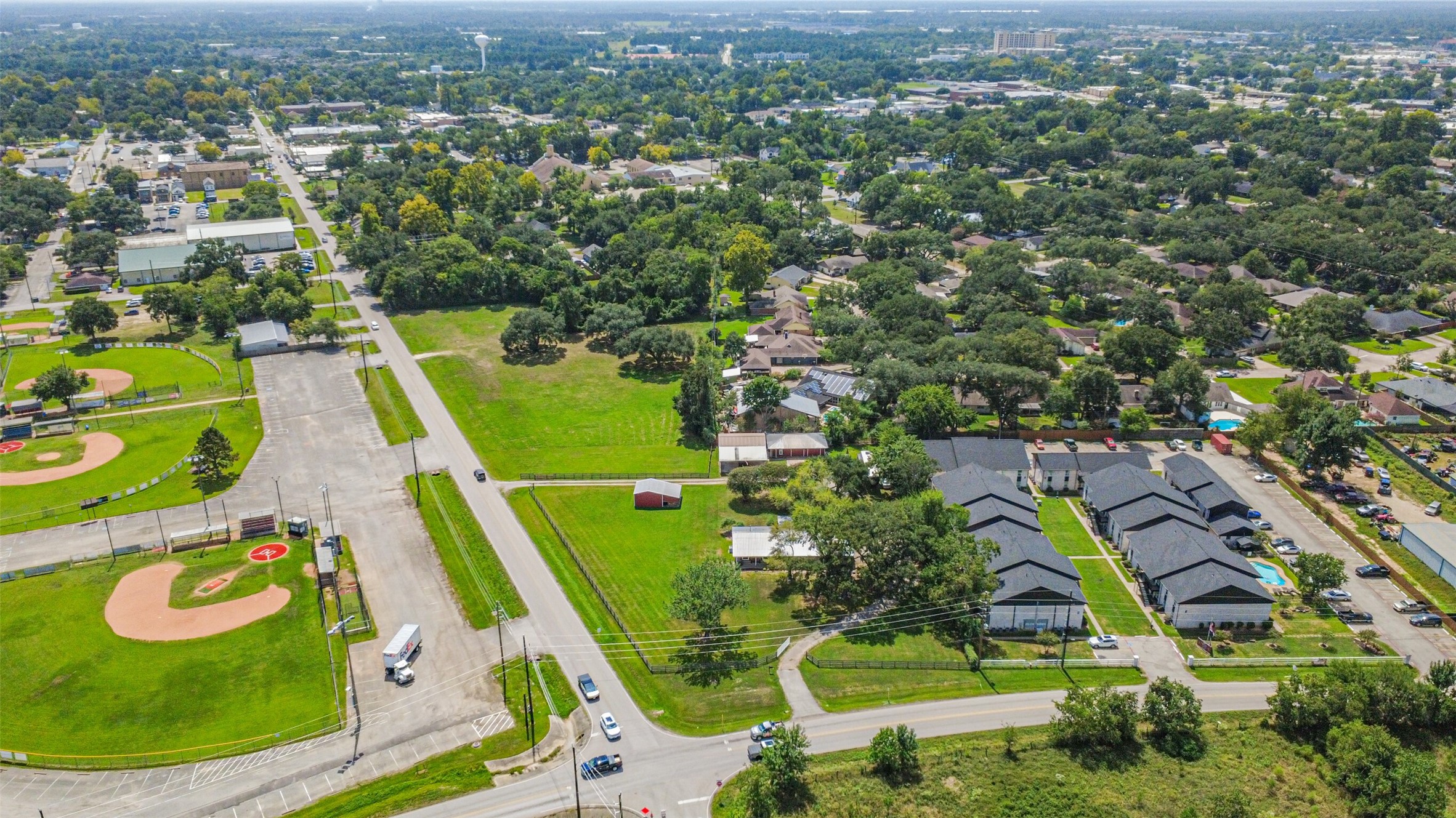 307 West Hufsmith Road Tomball, TX 77375 - Photo 6 of 44 Spacious neighborhood with lush greenery, modern homes, and nearby recreational fields, offering a perfect blend of community and convenience.