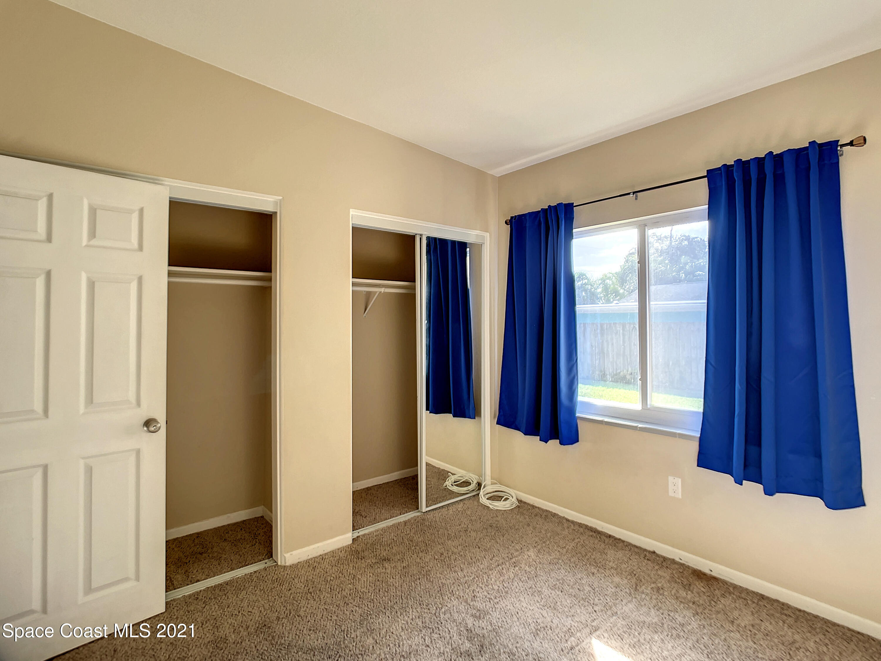 946 Santa Cruz Road Cocoa Beach, FL 32931 - Photo 13 of 26 an empty room with windows