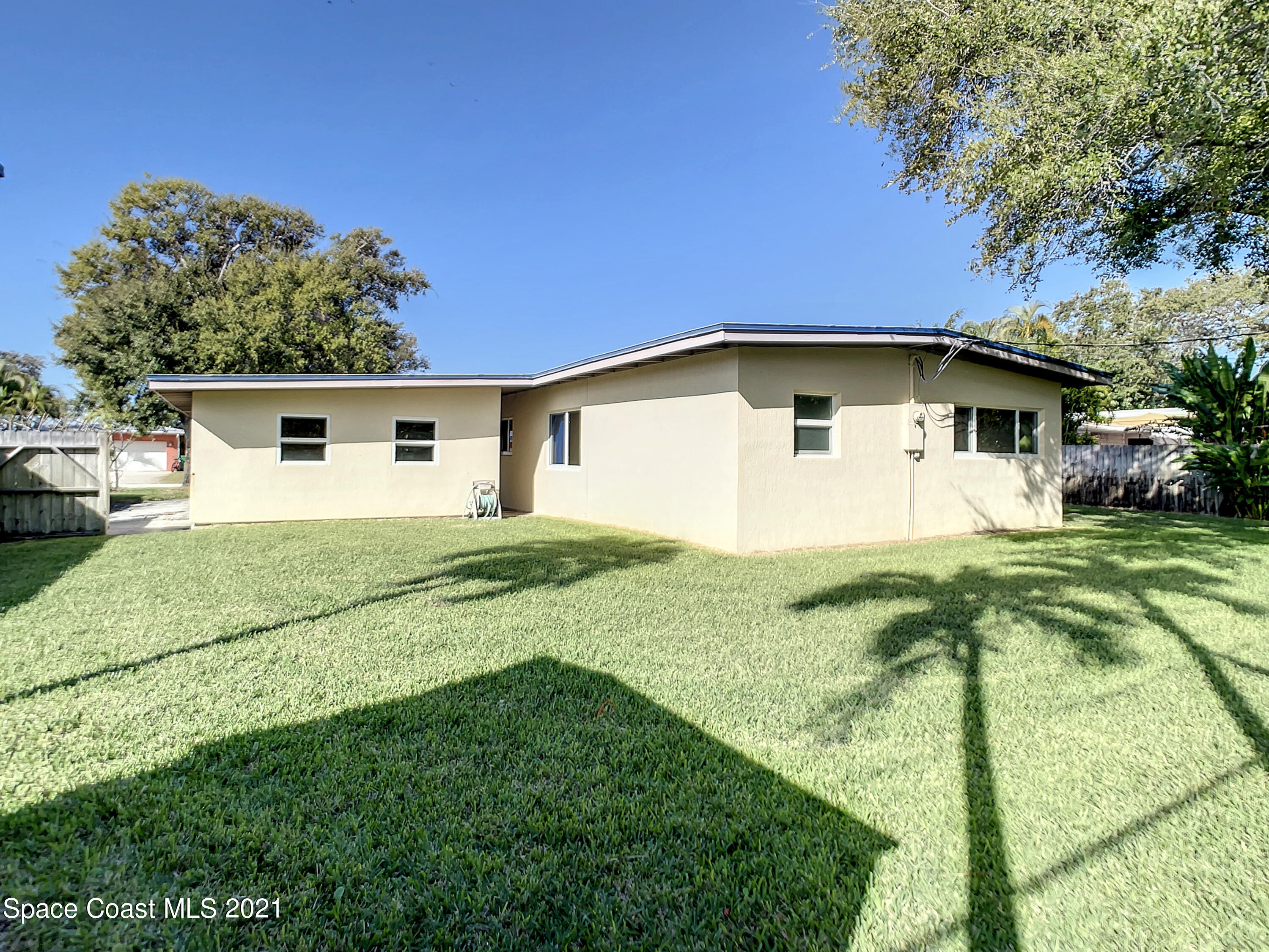 946 Santa Cruz Road Cocoa Beach, FL 32931 - Photo 23 of 26 a view of a white house with a yard