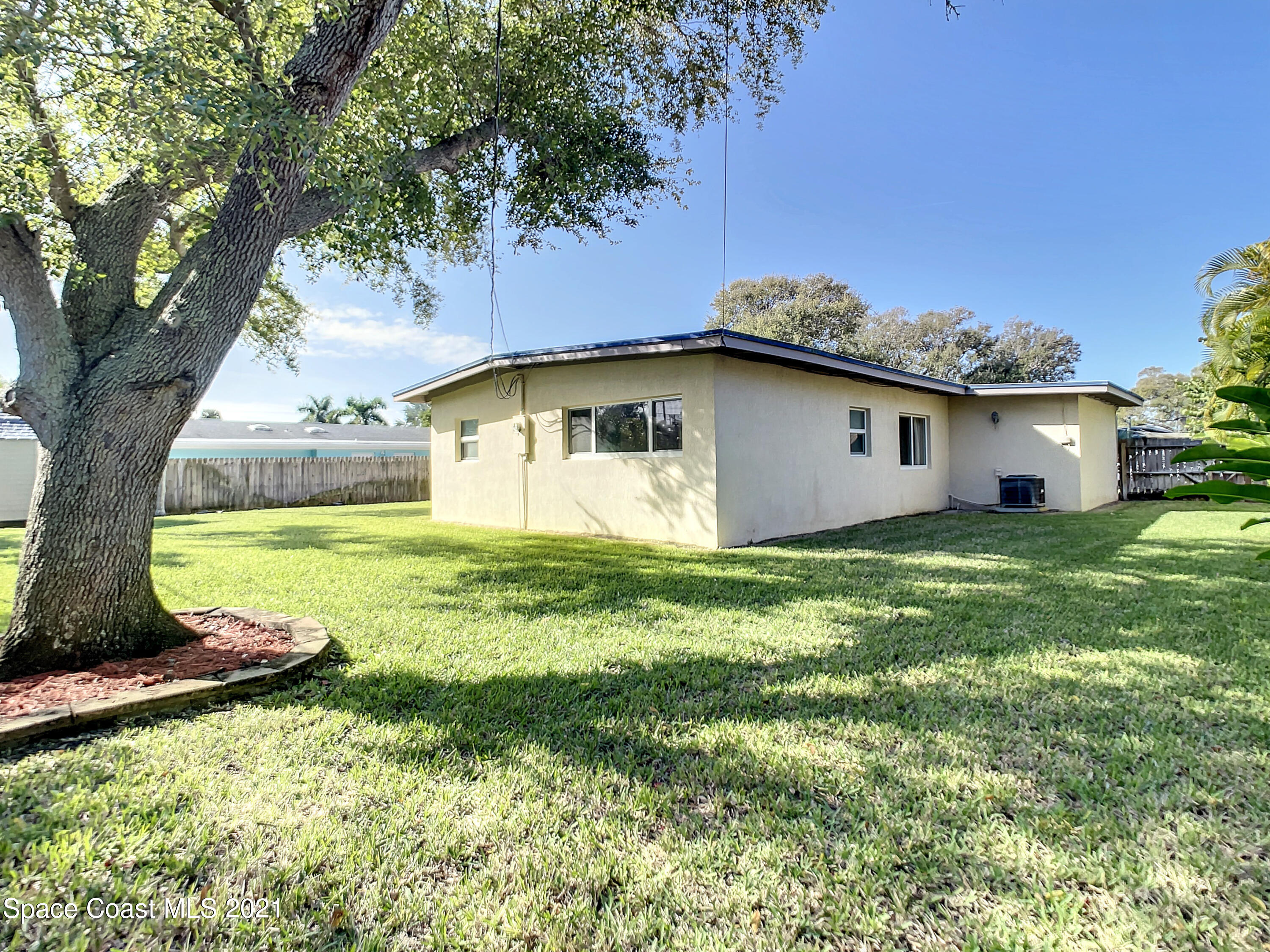 946 Santa Cruz Road Cocoa Beach, FL 32931 - Photo 24 of 26 a house view with a garden space