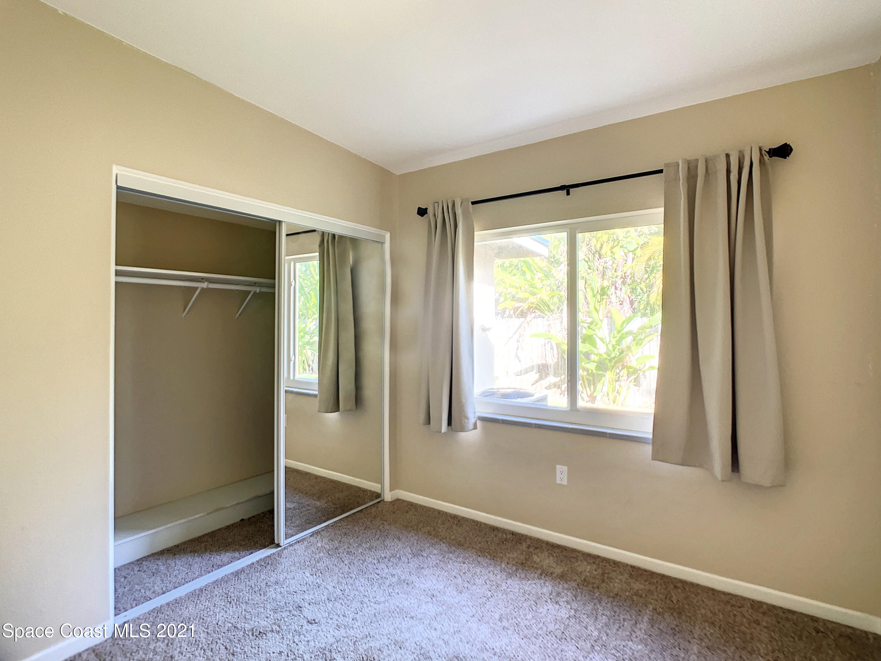 946 Santa Cruz Road Cocoa Beach, FL 32931 - Photo 10 of 26 a view of an empty room with a window