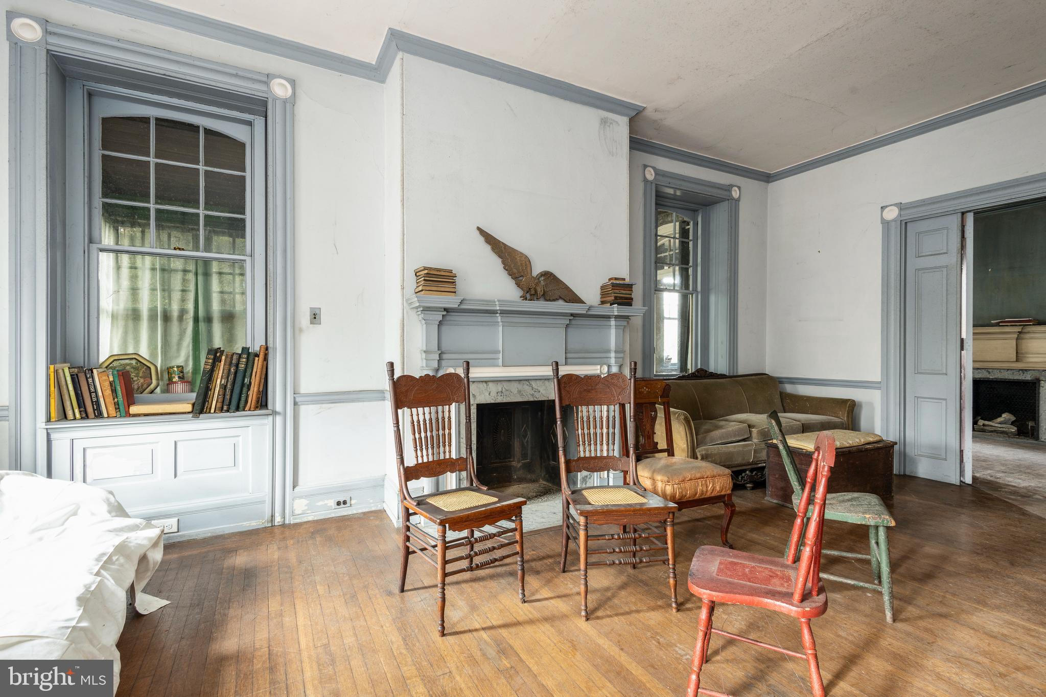 8221 Seminole Street Philadelphia, PA 19118 - Photo 14 of 20 a living room with furniture a fireplace and dining table
