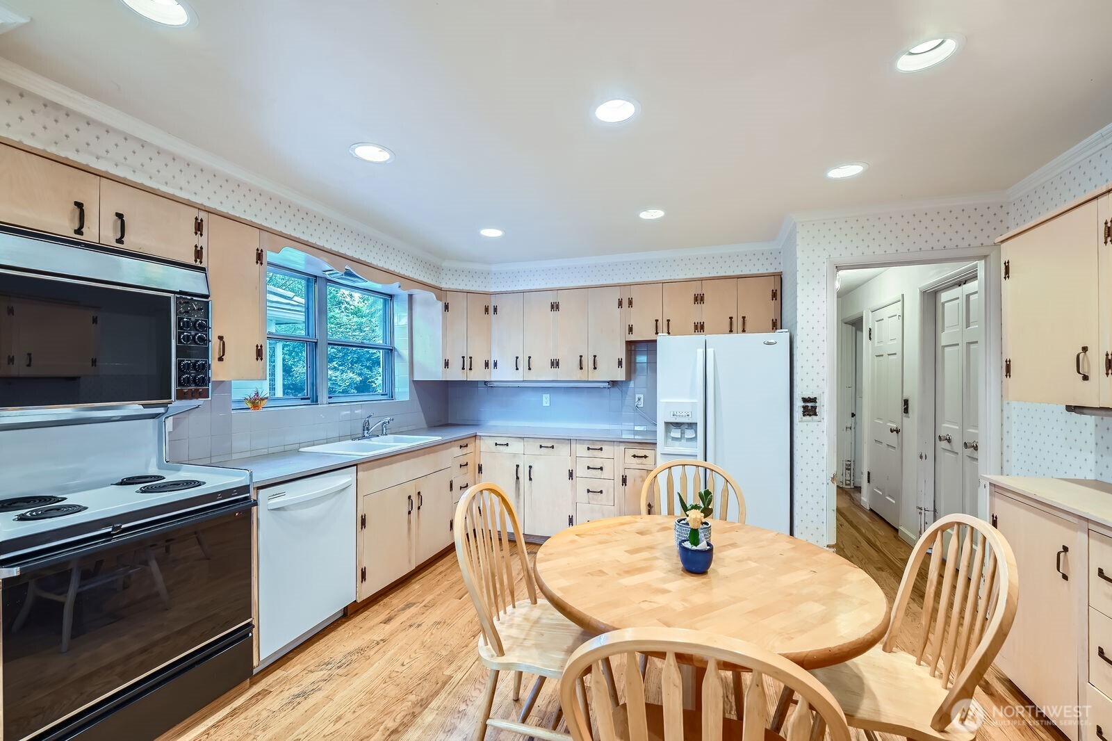 3706 84th Avenue Southeast Mercer Island, WA 98040 - Photo 12 of 38 a kitchen with stainless steel appliances granite countertop a kitchen island a stove a table and chairs