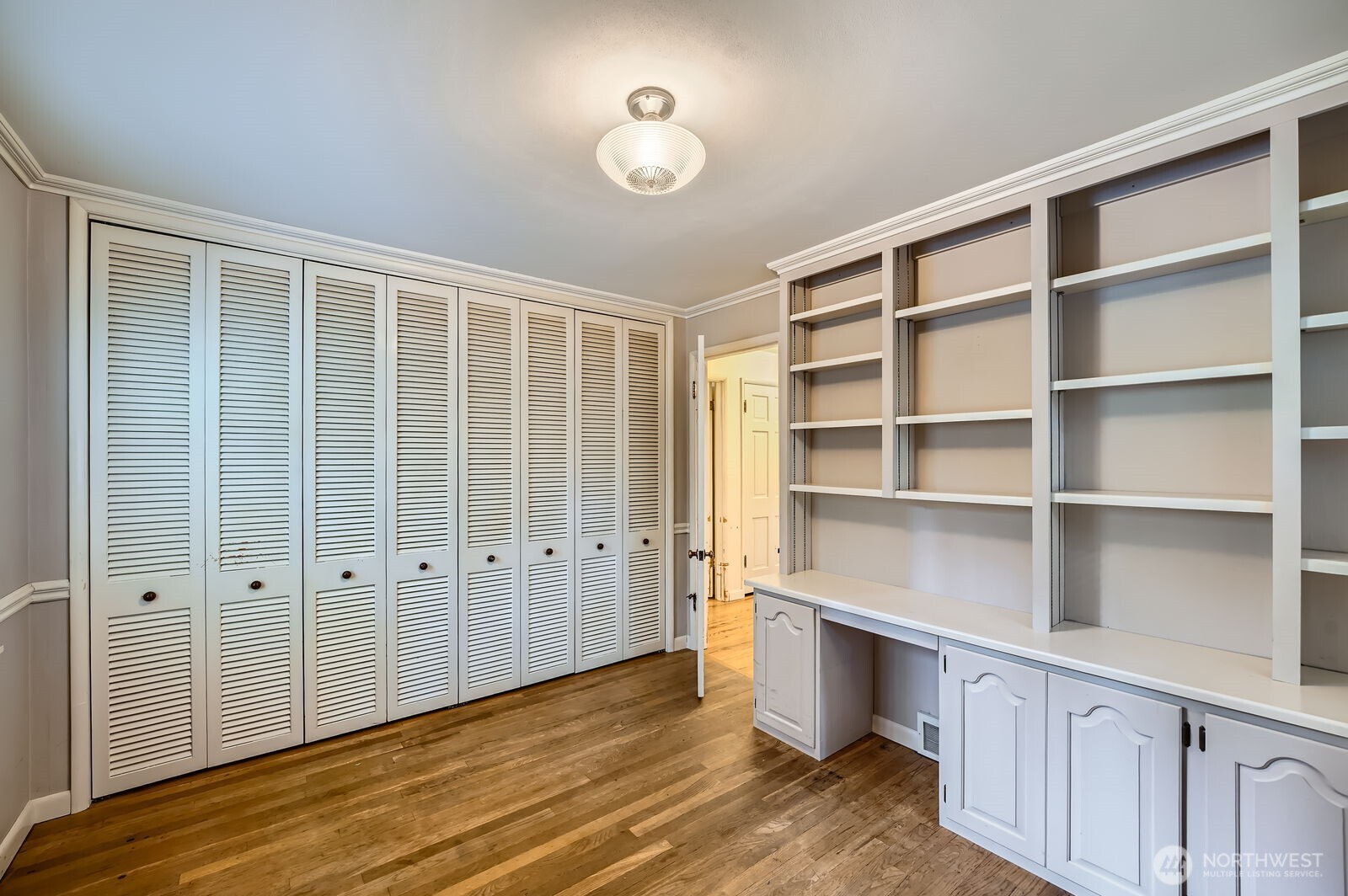 3706 84th Avenue Southeast Mercer Island, WA 98040 - Photo 15 of 38 a view of an empty room with a window and wooden floor