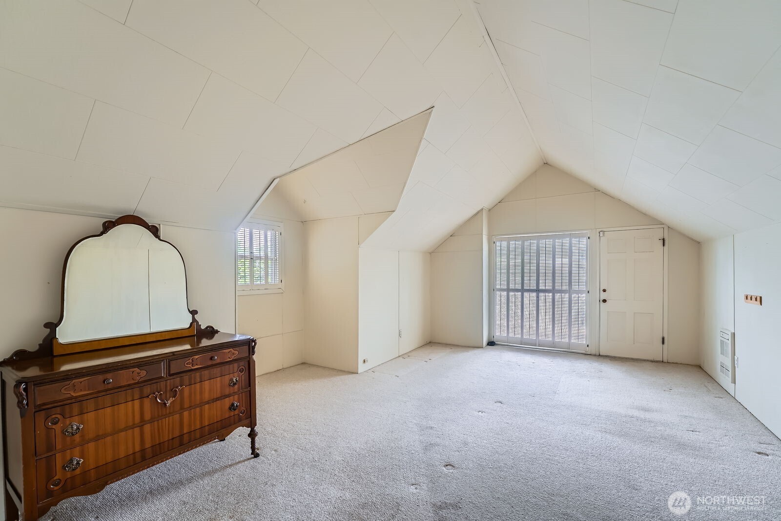 3706 84th Avenue Southeast Mercer Island, WA 98040 - Photo 22 of 38 a room with a dresser and a wooden floor