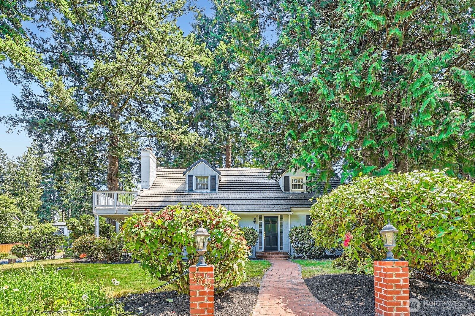3706 84th Avenue Southeast Mercer Island, WA 98040 - Photo 3 of 38 a front view of a house with a garden