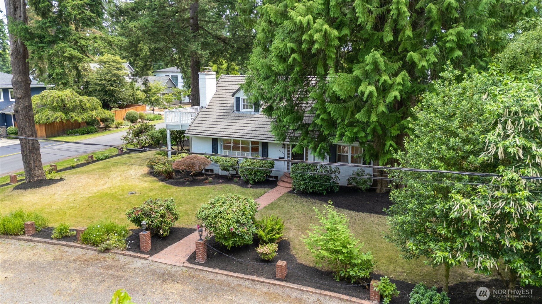 3706 84th Avenue Southeast Mercer Island, WA 98040 - Photo 34 of 38 a view of a house with a yard and garden
