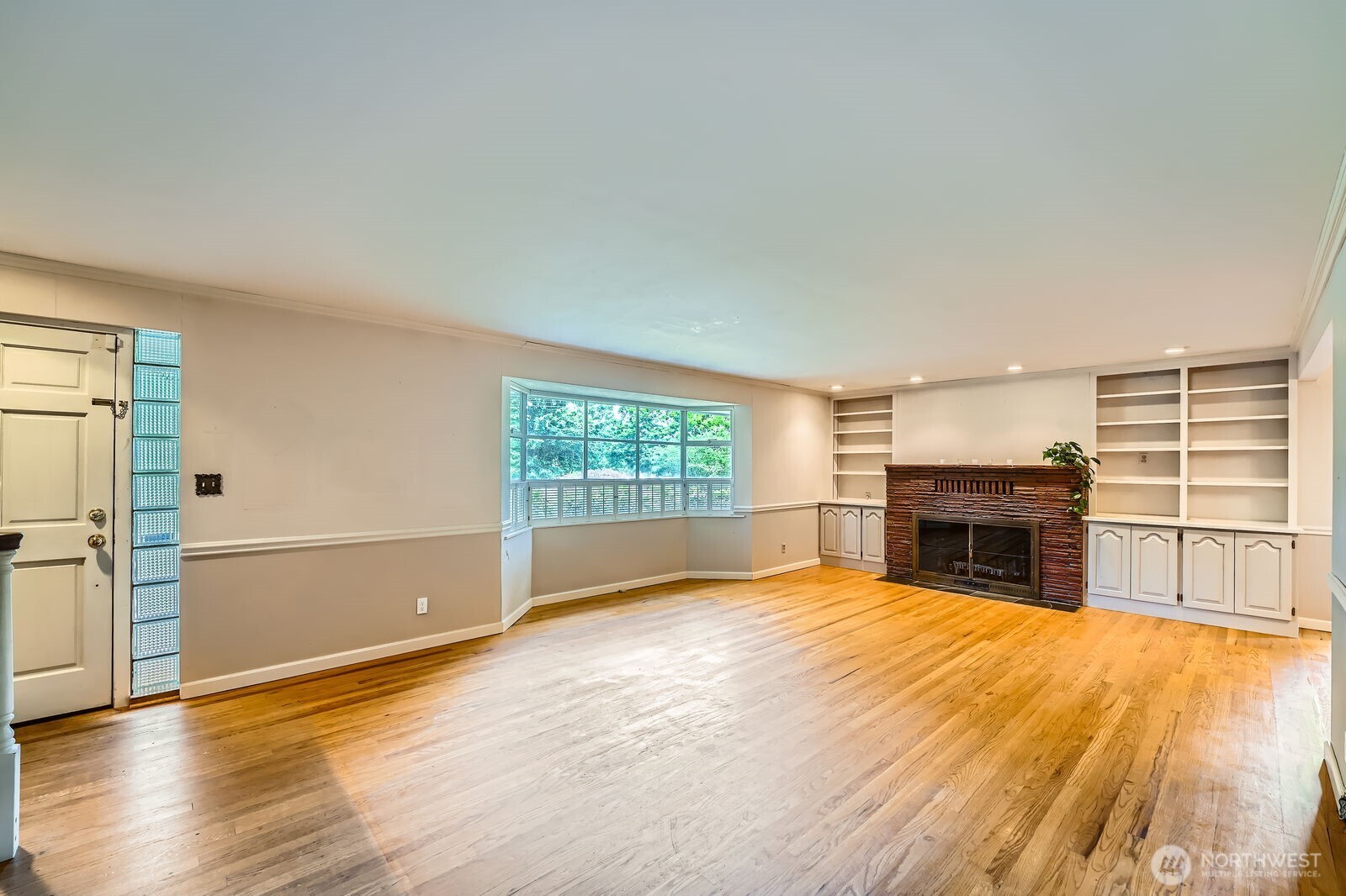 3706 84th Avenue Southeast Mercer Island, WA 98040 - Photo 6 of 38 a view of empty room with a fireplace and wooden floor