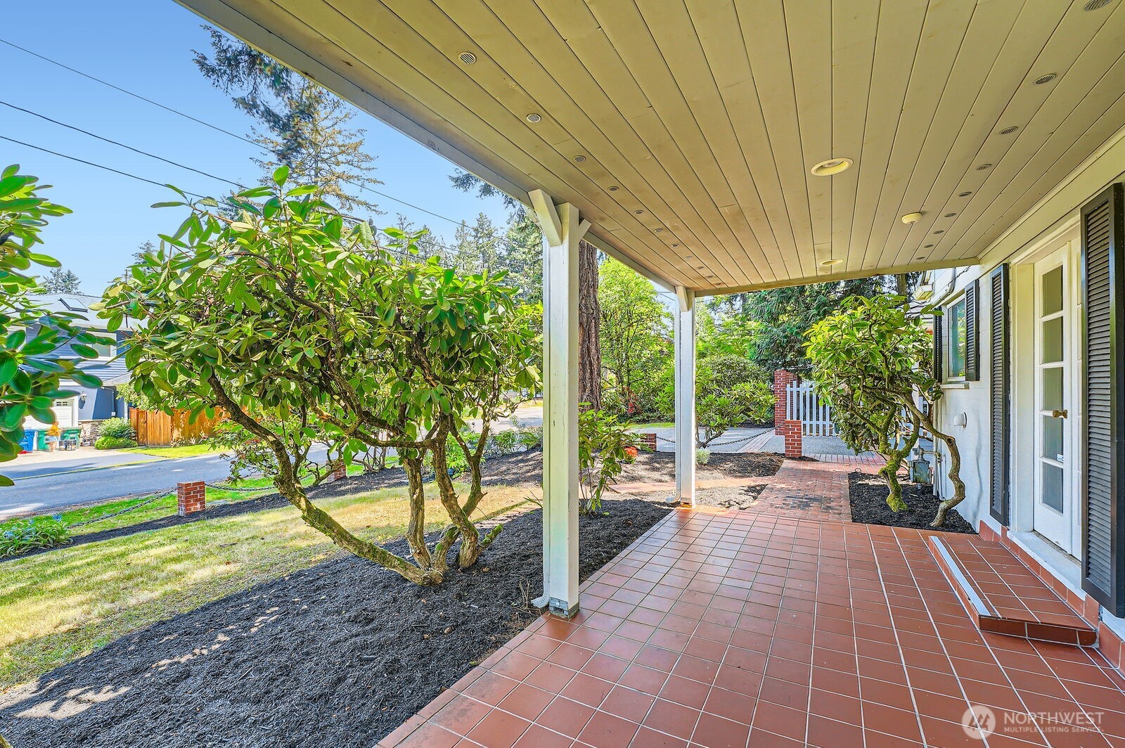 3706 84th Avenue Southeast Mercer Island, WA 98040 - Photo 10 of 38 a view of a patio with table and chairs potted plants and floor to ceiling window