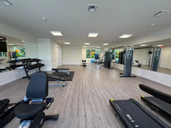 a room with lots of chairs and wooden floor