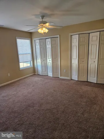 an empty room with windows and entrance