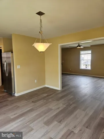 a view of a room with wooden floor and window