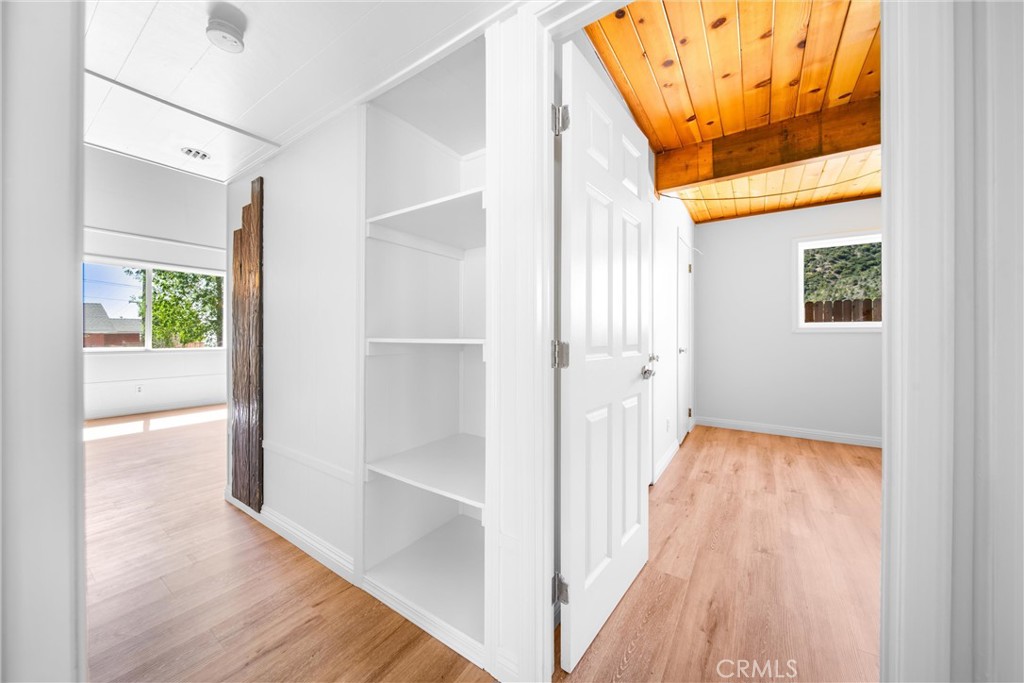 4225 Alcot Trail Frazier Park, CA 93225 - Photo 11 of 31 a view of a hallway with wooden floor and a bathroom