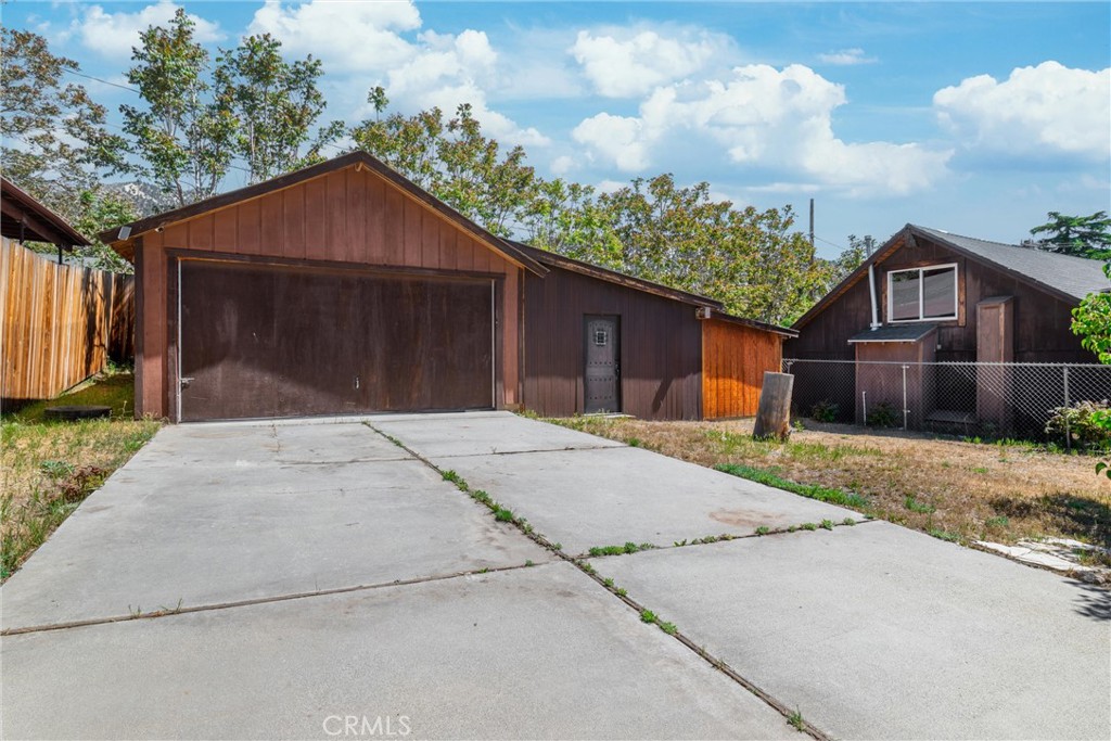 4225 Alcot Trail Frazier Park, CA 93225 - Photo 20 of 31 a front view of a house with a yard and garage