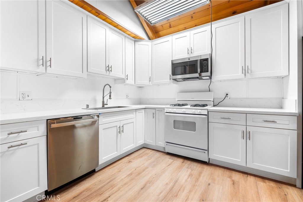 4225 Alcot Trail Frazier Park, CA 93225 - Photo 5 of 31 a kitchen with stainless steel appliances granite countertop white cabinets a sink and dishwasher